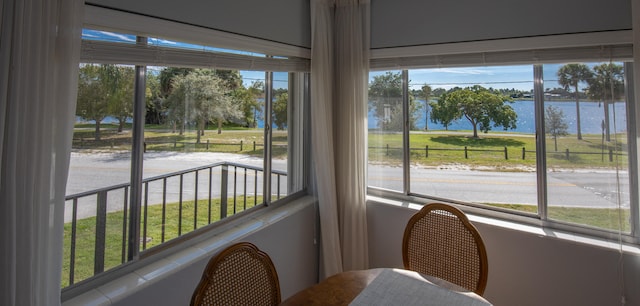 sunroom / solarium featuring a water view and a wealth of natural light