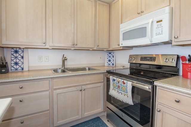 kitchen featuring light brown cabinets, sink, and stainless steel electric range