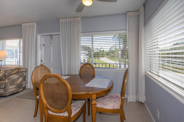 tiled dining room featuring ceiling fan