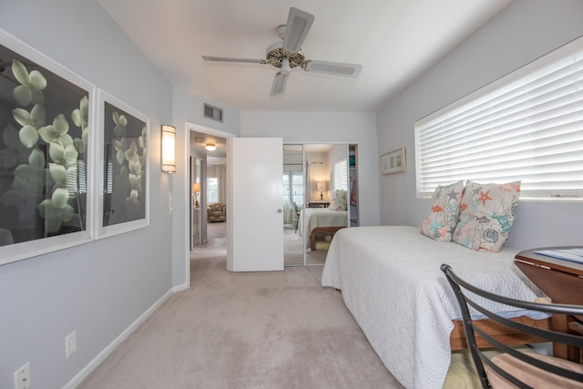 bedroom with light carpet, a closet, and ceiling fan