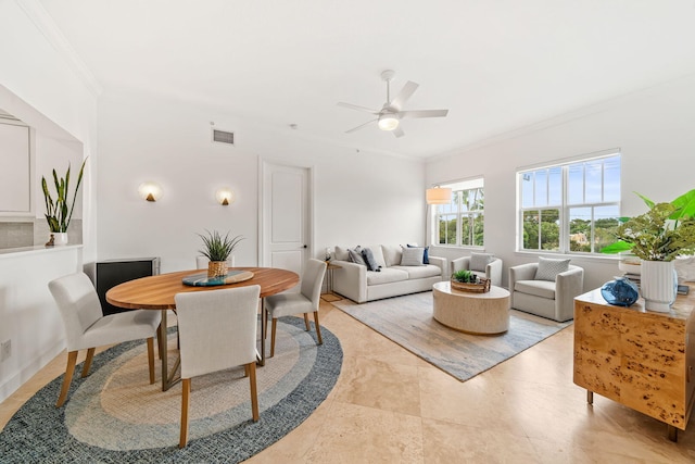 dining area featuring ceiling fan and ornamental molding