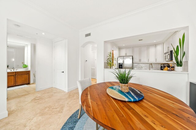 dining space featuring light tile patterned floors, ceiling fan, and crown molding