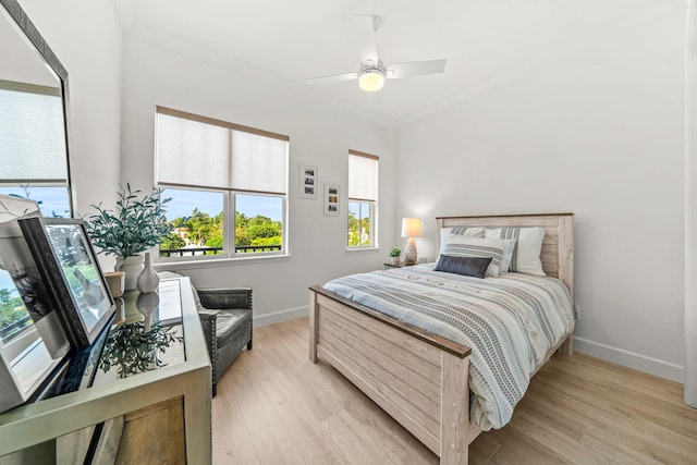 bedroom with ceiling fan, light hardwood / wood-style floors, and crown molding