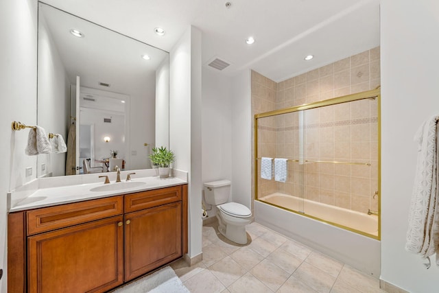 full bathroom featuring vanity, toilet, tile patterned flooring, and combined bath / shower with glass door