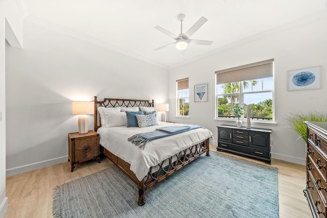 bedroom featuring ceiling fan, crown molding, and light hardwood / wood-style floors