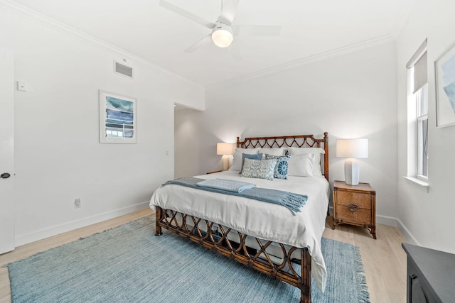 bedroom featuring ceiling fan, crown molding, and light hardwood / wood-style flooring