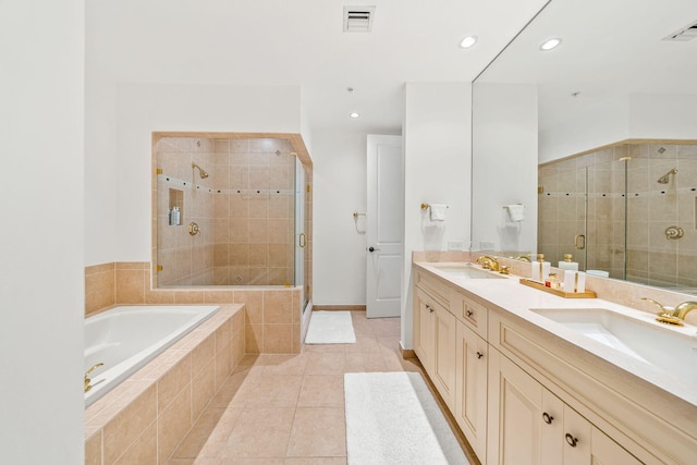 bathroom featuring tile patterned flooring, vanity, and separate shower and tub