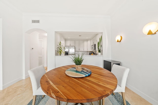 dining room featuring crown molding