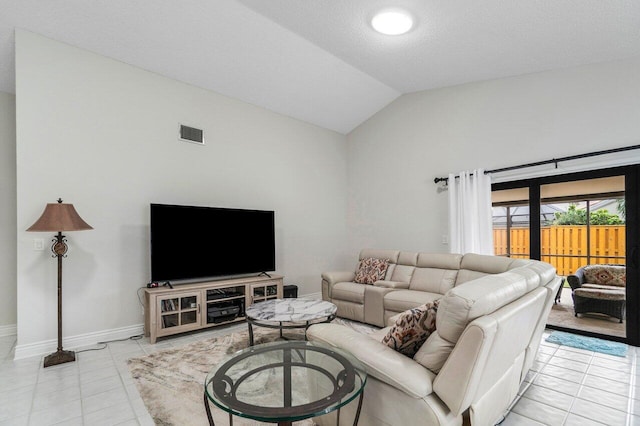 tiled living room with lofted ceiling