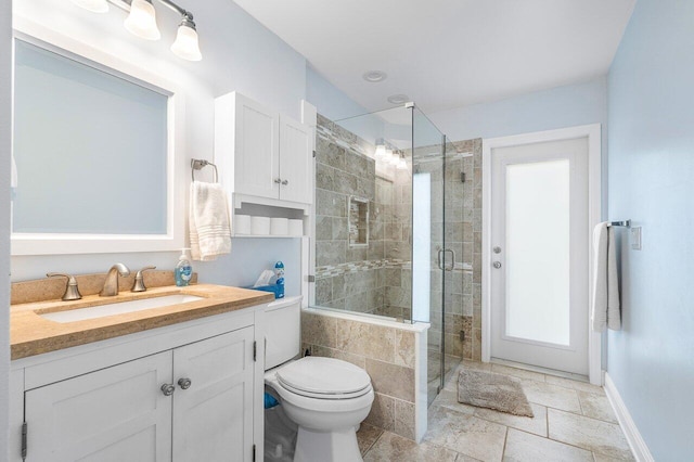 bathroom featuring walk in shower, vanity, and toilet