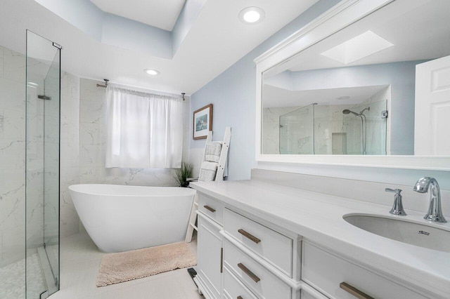 bathroom with vanity, a skylight, tile patterned floors, and shower with separate bathtub