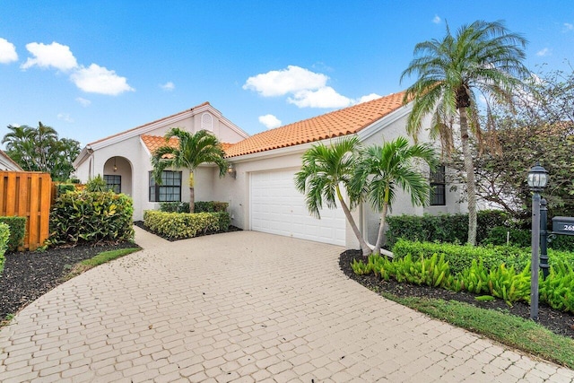 mediterranean / spanish-style home with a garage