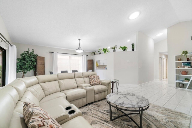 living room with lofted ceiling, light tile patterned floors, and a textured ceiling