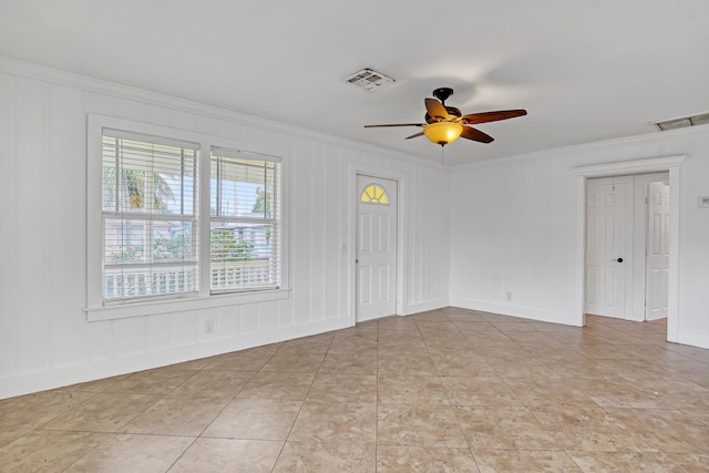 spare room with crown molding and ceiling fan