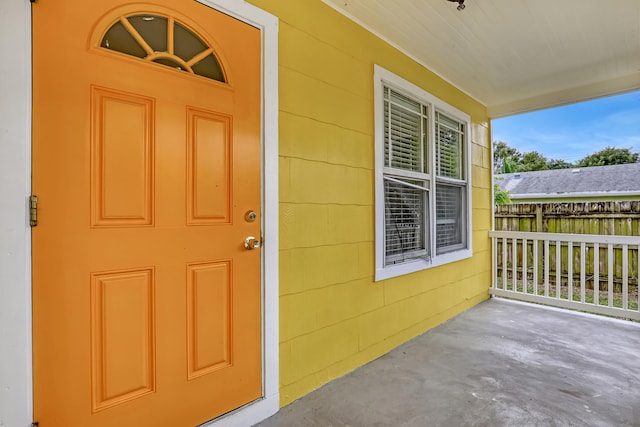 view of exterior entry featuring a porch