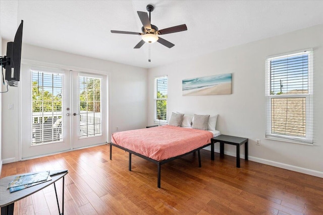 bedroom featuring hardwood / wood-style floors, french doors, access to outside, and ceiling fan