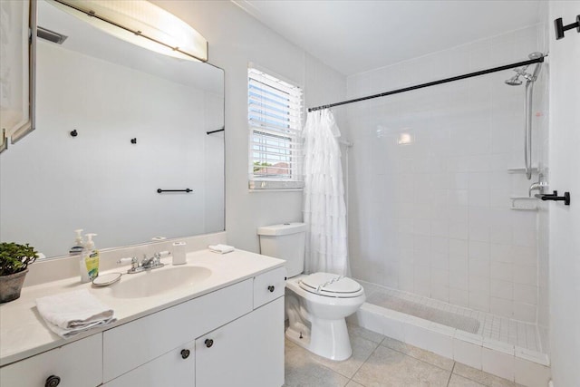 bathroom featuring tile patterned floors, vanity, toilet, and walk in shower