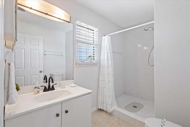 bathroom featuring tile patterned floors, curtained shower, vanity, and toilet