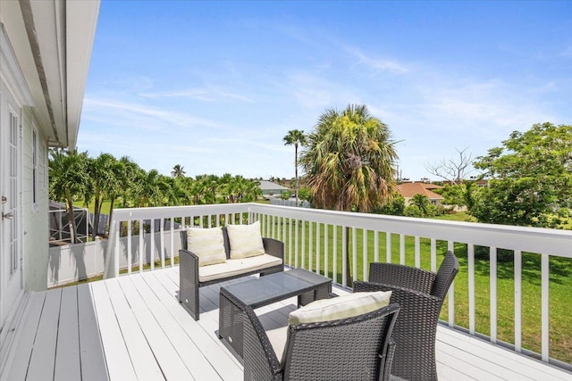 wooden terrace featuring a yard