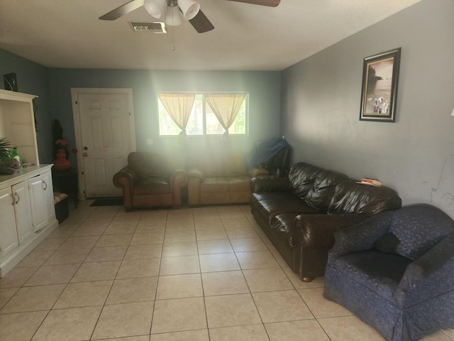 living room with ceiling fan and light tile patterned floors