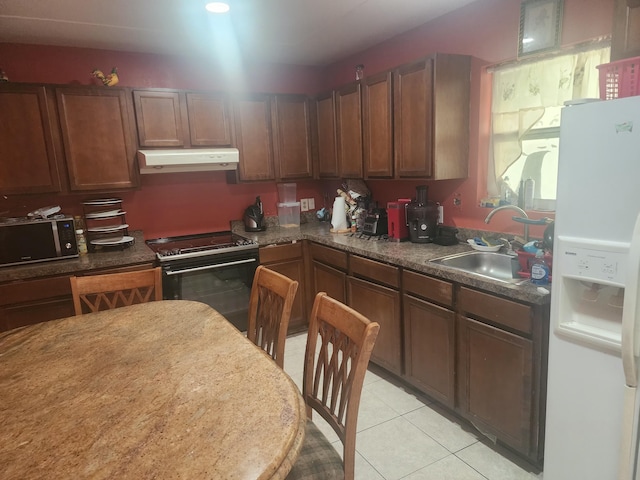 kitchen with light tile patterned floors, black range with electric stovetop, white fridge with ice dispenser, and sink