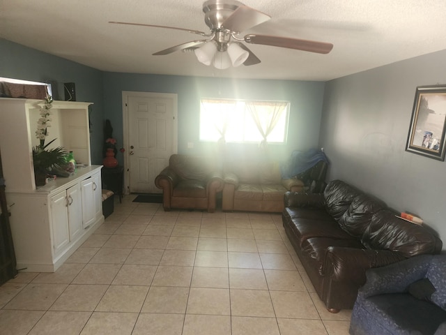 living room featuring ceiling fan and light tile patterned flooring