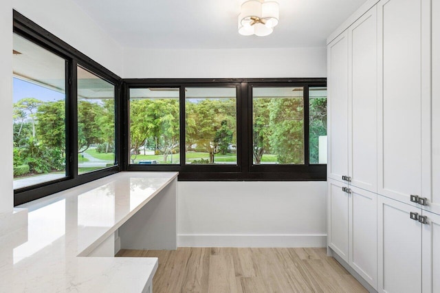 unfurnished sunroom featuring a notable chandelier and plenty of natural light