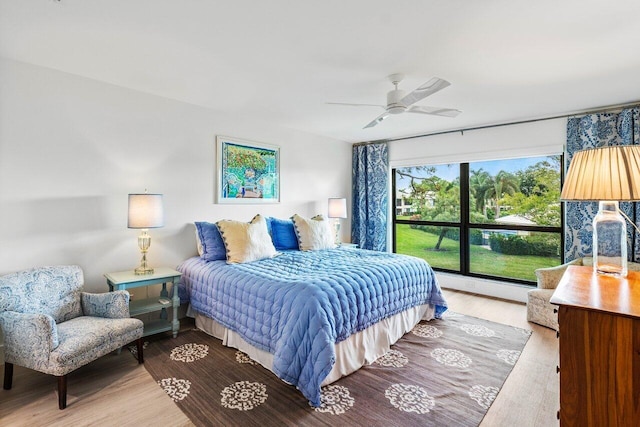 bedroom with light wood-type flooring and ceiling fan