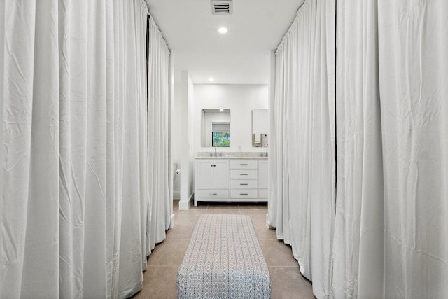 bathroom with tile patterned flooring and vanity