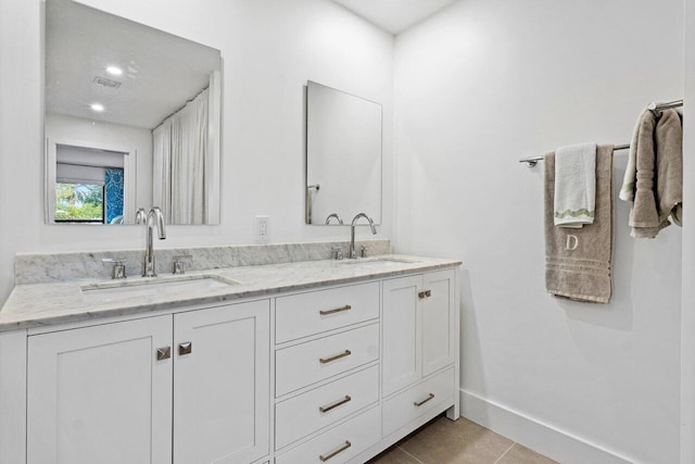 bathroom featuring tile patterned flooring and vanity