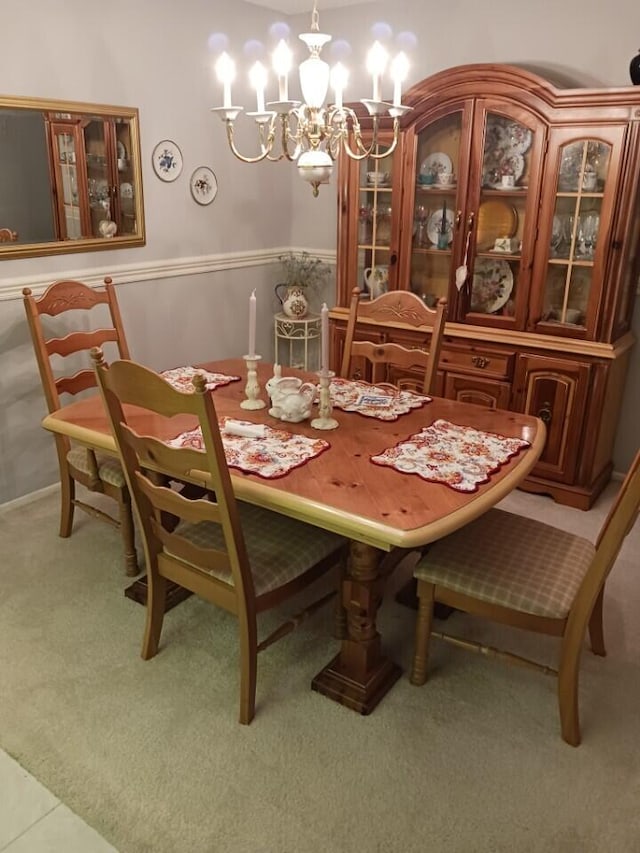 dining area featuring carpet floors and a chandelier