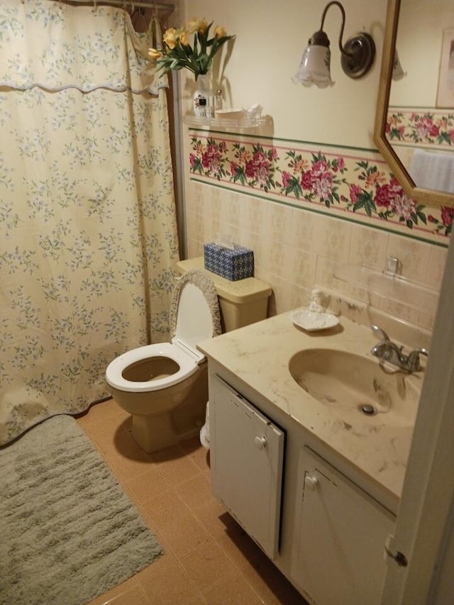 bathroom with vanity, curtained shower, toilet, and tile walls