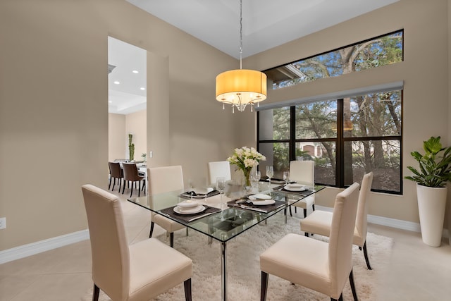 dining area featuring a notable chandelier and light tile patterned flooring