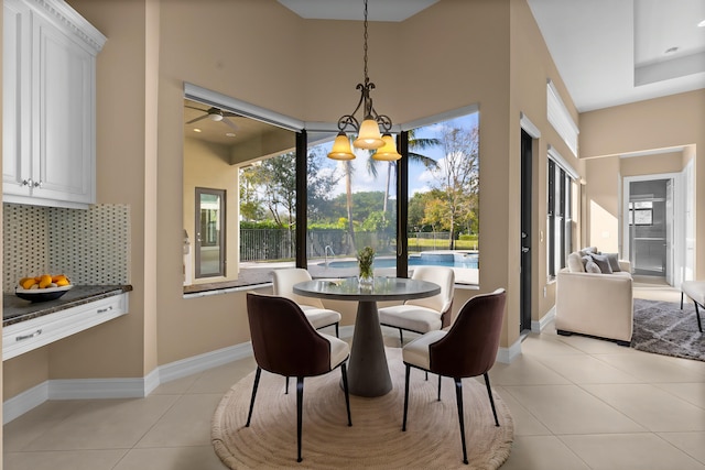 dining space featuring light tile patterned flooring and a chandelier