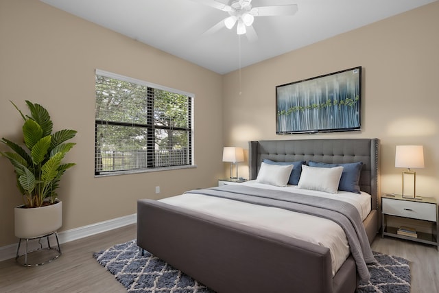 bedroom with ceiling fan and light wood-type flooring