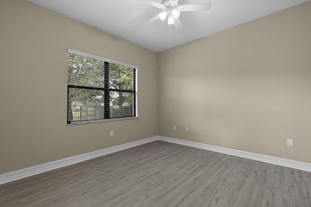 spare room featuring hardwood / wood-style floors and ceiling fan