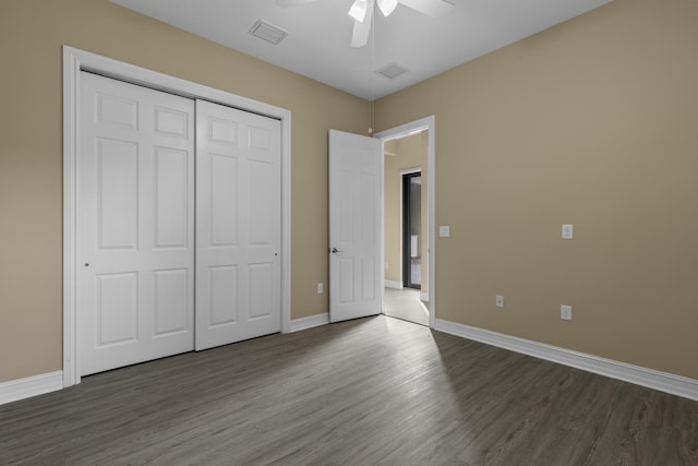 unfurnished bedroom featuring dark hardwood / wood-style flooring, a closet, and ceiling fan