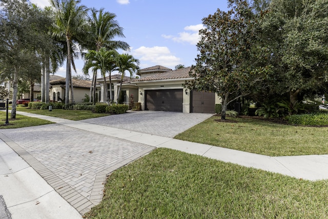 view of front of property with a garage and a front yard