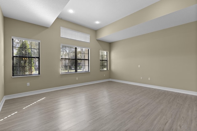 unfurnished room with light wood-type flooring