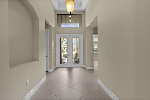 foyer entrance with light tile patterned floors and french doors