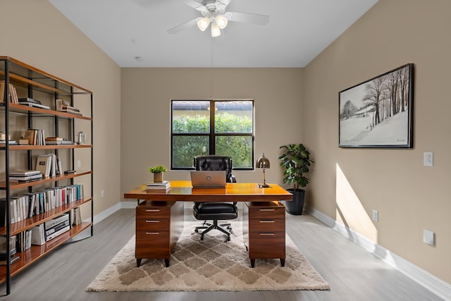 office with ceiling fan and light hardwood / wood-style floors