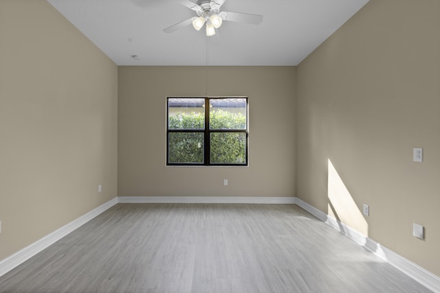 empty room with ceiling fan and light wood-type flooring