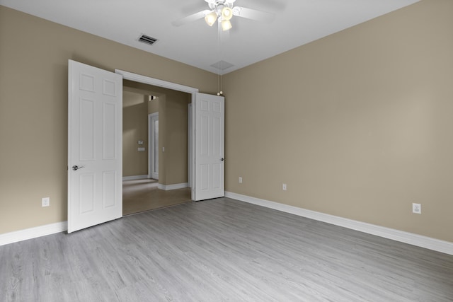 unfurnished bedroom with ceiling fan and light wood-type flooring