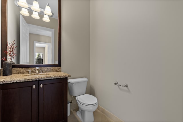 bathroom featuring tile patterned floors, vanity, and toilet