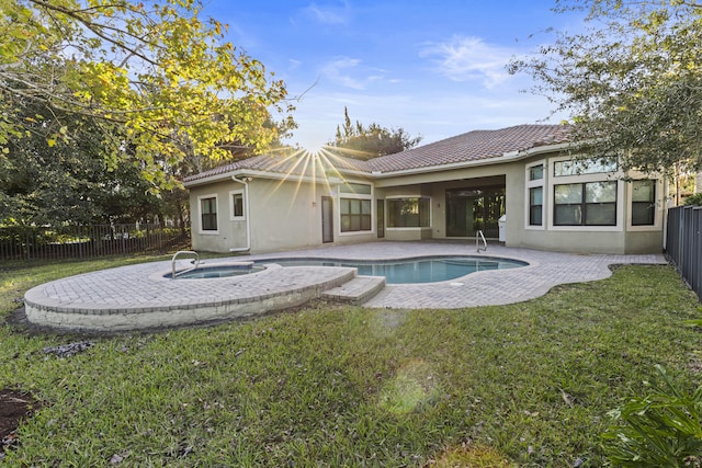 view of swimming pool featuring an in ground hot tub, a yard, and a patio area