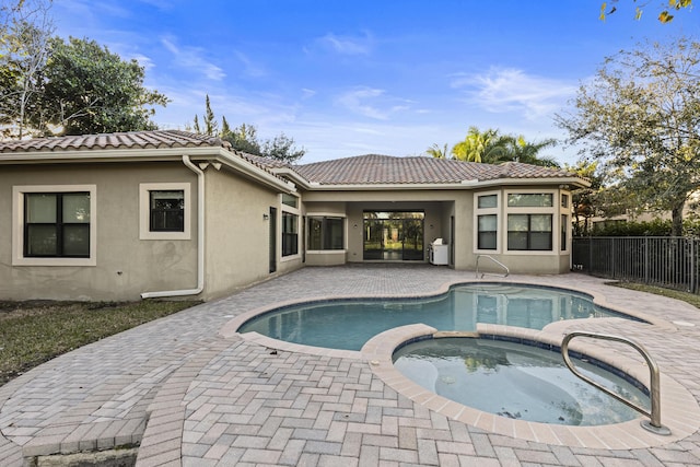 view of swimming pool with a patio area and an in ground hot tub