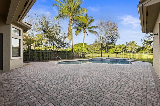 view of swimming pool with an in ground hot tub and a patio area