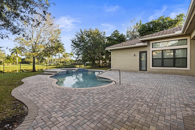 view of pool featuring a patio and an in ground hot tub