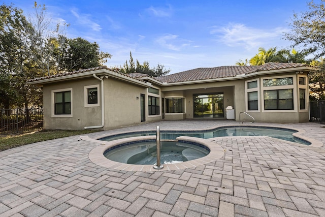 view of pool featuring an in ground hot tub and a patio area