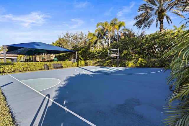 view of basketball court featuring a playground